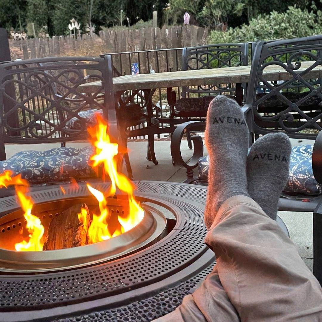 Existing customer photo of grey Avena socks beside a fire pit