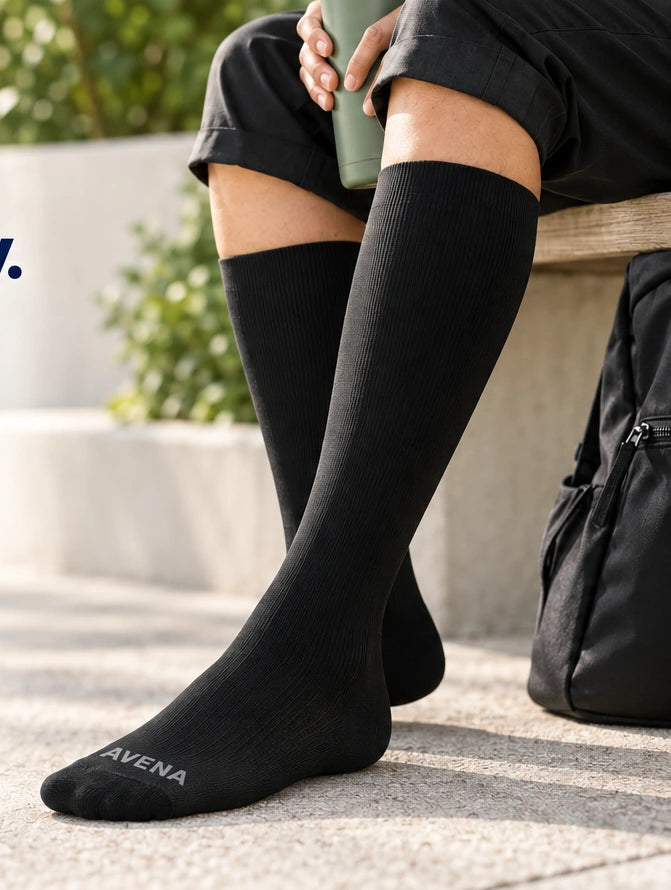 Person taking a seated break while wearing black Avena compression socks