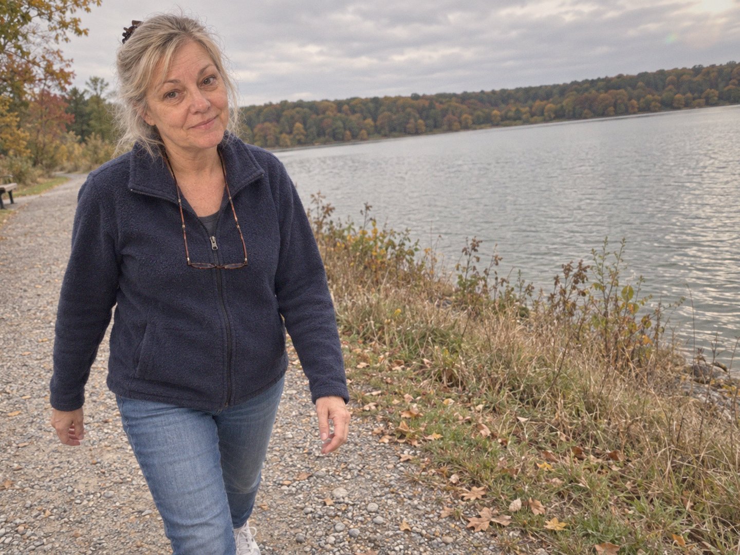 Linda walking the gravel path by the reservoir