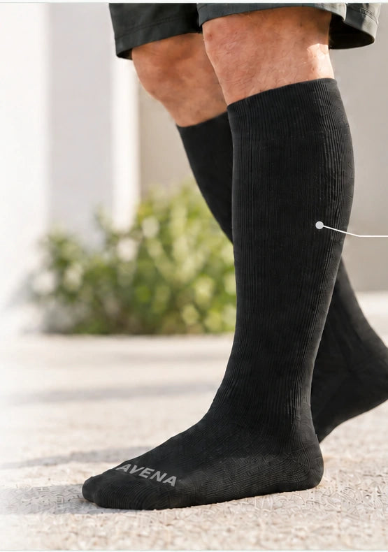 Black Avena compression socks worn outdoors, showing the lower leg and cushioned foot