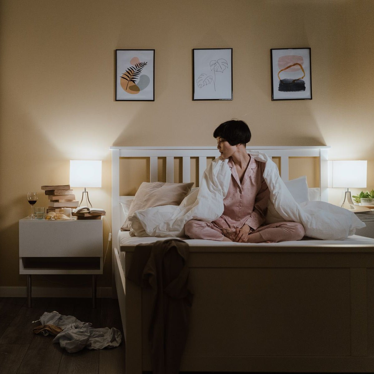 Woman sitting up awake in bed at night