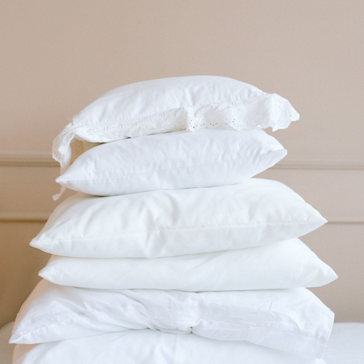 A tall stack of ordinary pillows