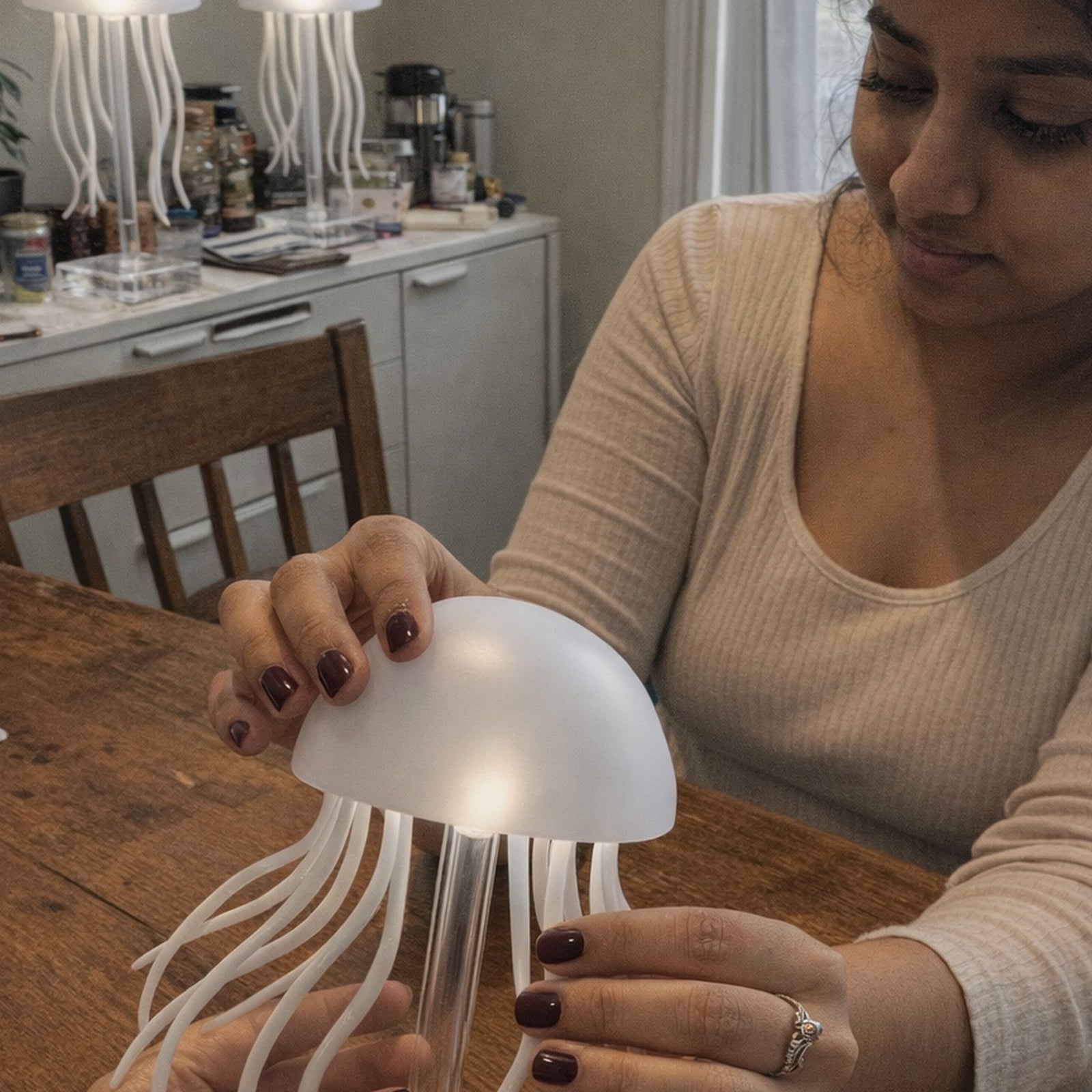 Two or three Dancing Glow Jellyfish lamps in Nora B.’s indoor room
